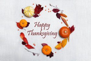 Happy Thanksgiving" text surrounded by a circular arrangement of pumpkins, leaves, and berries on a textured white background.