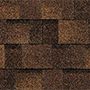Close-up view of a textured brown brick wall, showing detailed patterns and variations in color.