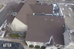 Aerial view of a large building with a brown shingle roof, slightly covered with snow, labeled "AFTER.