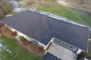 A bird 's eye view of a house with a person standing on the roof.