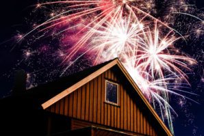 A house with fireworks in the background.
